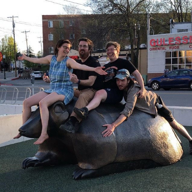 Summiteers sit comically on Bucky badger sculpture located on corner of Monroe and Regent. (Circa summer 2020)